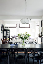 一层起居室内的色彩以白色为主，无论是沙发还是靠垫都以细细的黑边“勾勒”，包括餐椅的选择也是黑色线条的“构成”。这些选择与搭配构成了室内风格的统一。